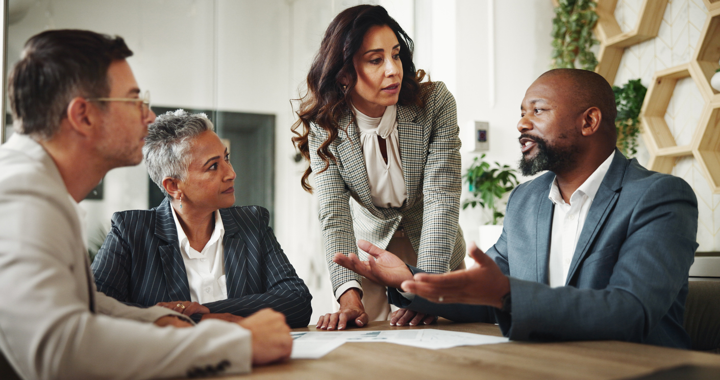 Businesspeople Meet Around a Conference Table in a Boardroom