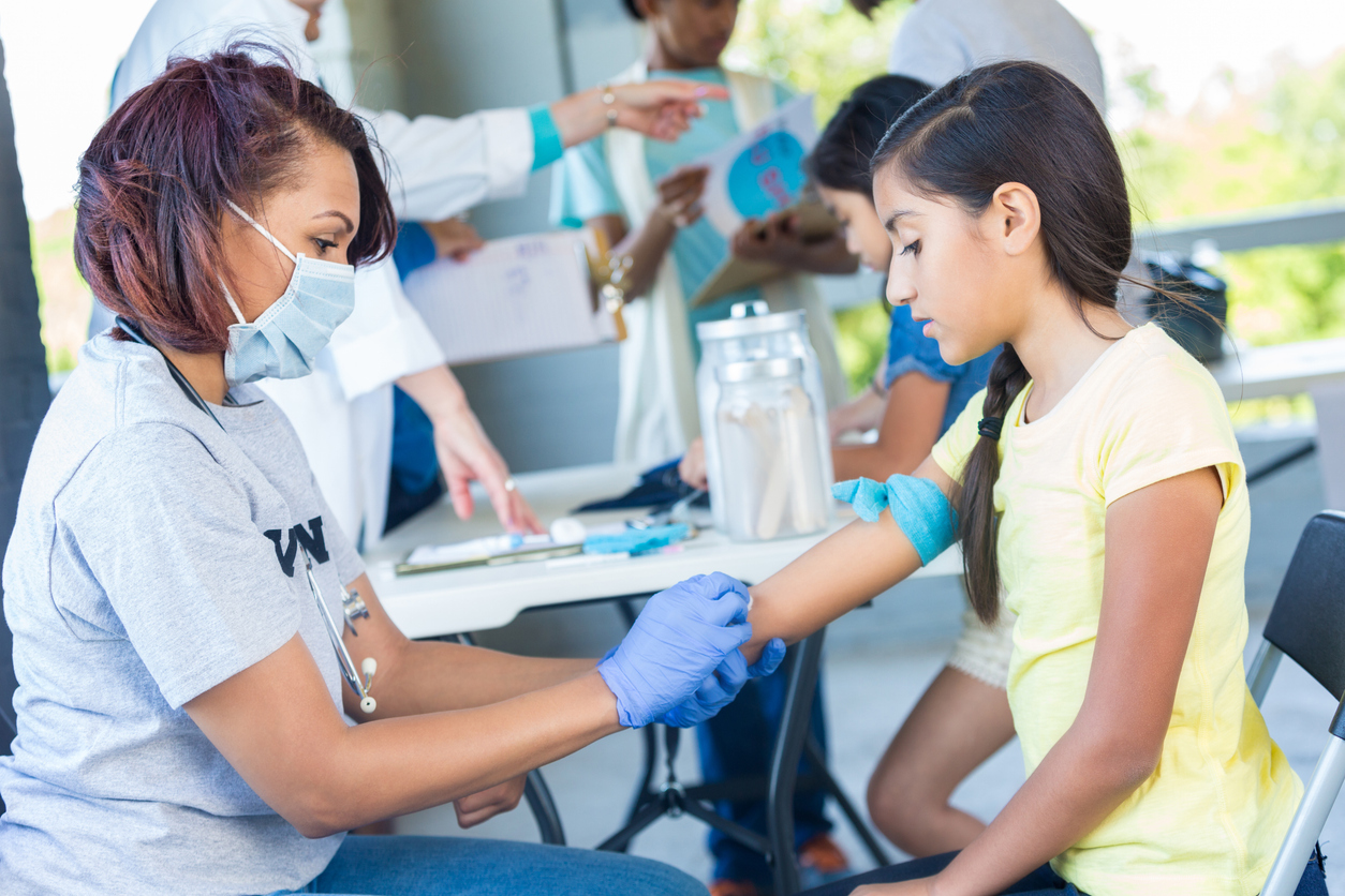 Volunteers Man a Public Health Screening POP up in a City Park..jpg