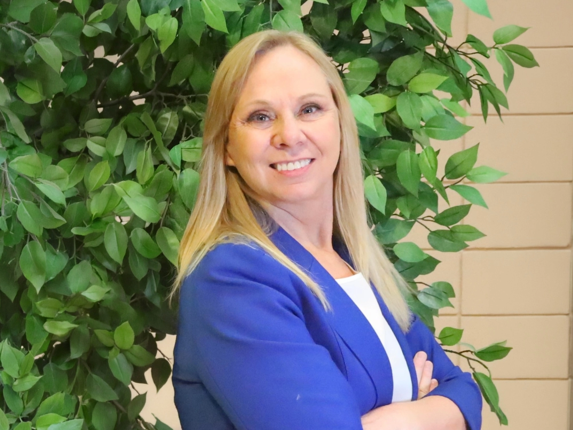 Headshot of Karen Lynn Webb, PhD, RN, standing in front of a plant.