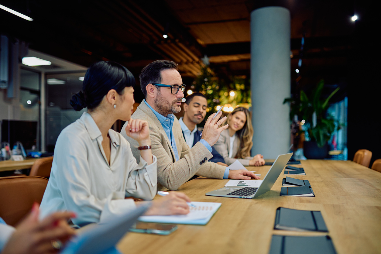 A Business Team Meets at a Conference Table